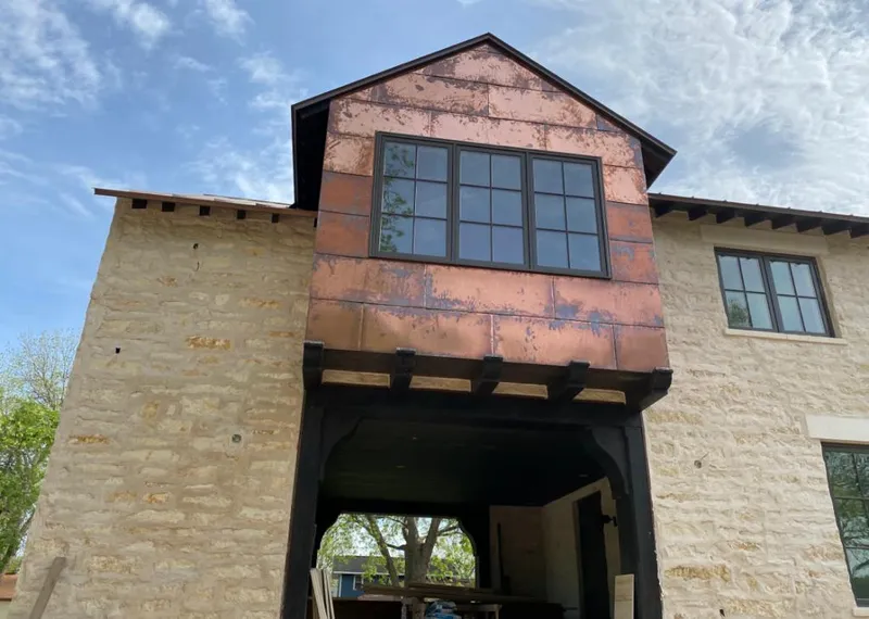 Copper metal panel facade on a stone building for Skylight Installation in St. Augustine Shores