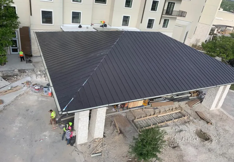 Metal roofing installation team working on a commercial building in St. Augustine Shores
